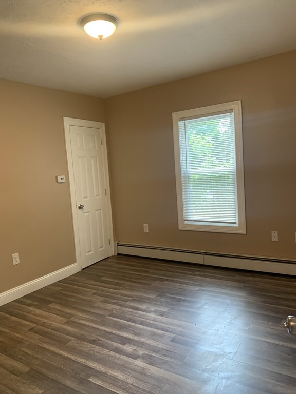 75 Pine Street Springfield, MA 01105 - Photo 35 of 40 an empty room with wooden floor and windows