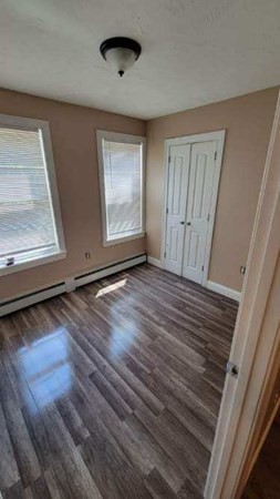 75 Pine Street Springfield, MA 01105 - Photo 9 of 40 an empty room with wooden floor and windows
