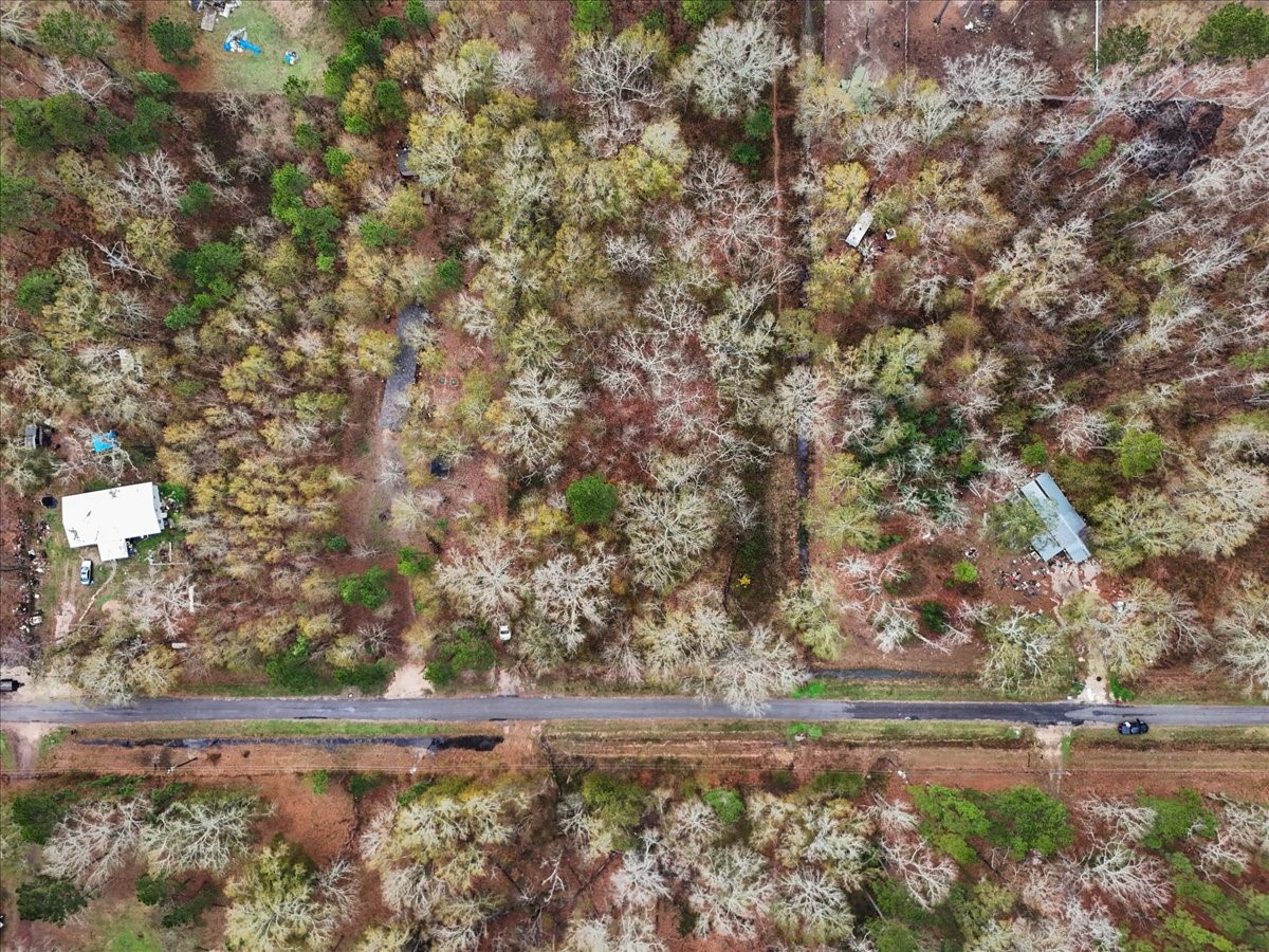 1209 County Road 2145 Cleveland, TX 77327 - Photo 8 of 17 a view of a yard with wooden fence
