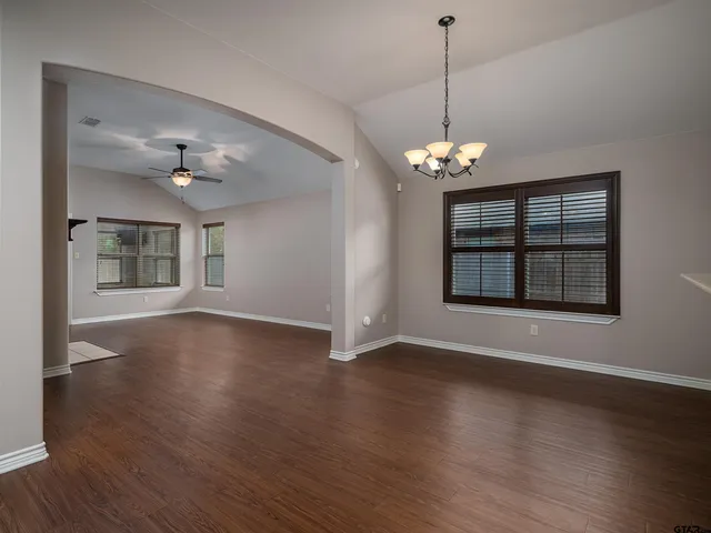 a view of wooden floor and a chandelier in a room