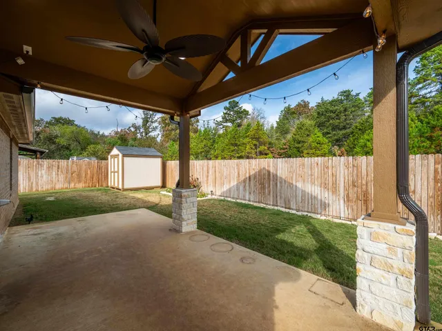 a view of a house with backyard and porch