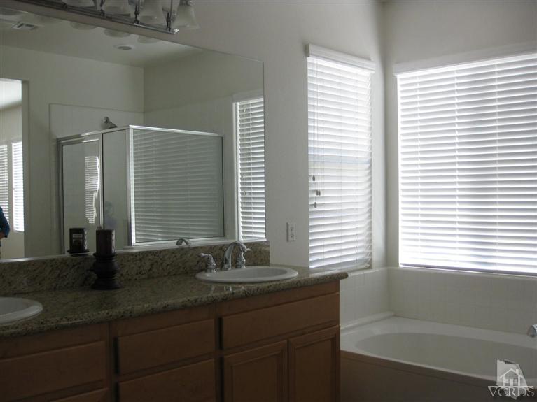 4774 Promenade Street Simi Valley, CA 93063 - Photo 12 of 21 a bathroom with a granite countertop sink and a large mirror