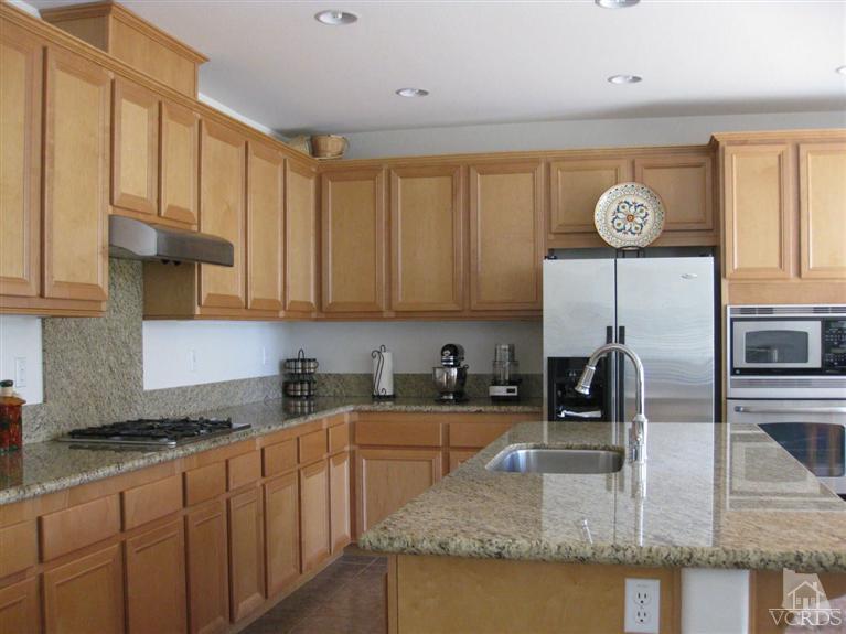 4774 Promenade Street Simi Valley, CA 93063 - Photo 15 of 21 a kitchen with stainless steel appliances granite countertop a sink a stove counter space and cabinets