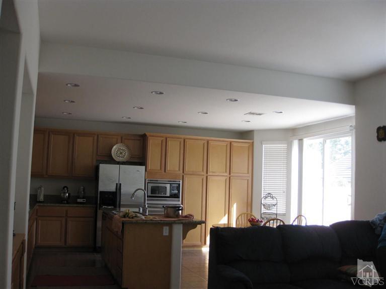 4774 Promenade Street Simi Valley, CA 93063 - Photo 18 of 21 a living room with kitchen island furniture a sink a window and stainless steel appliances