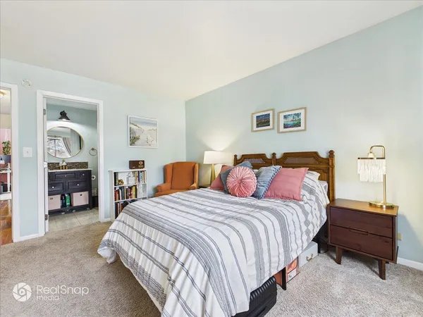 a bedroom with a bed and a view of bathroom