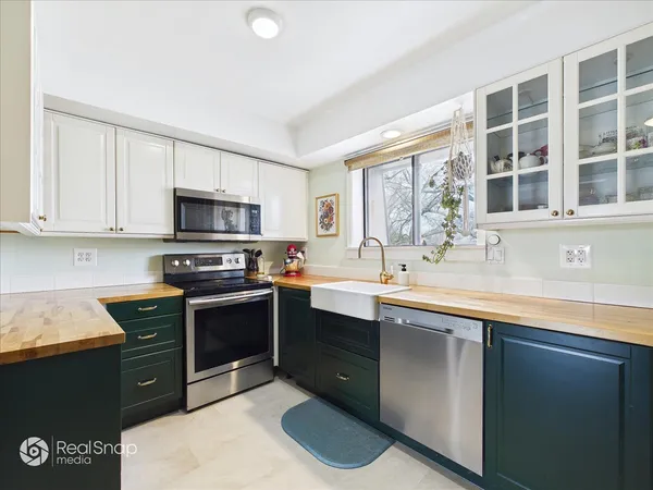 a kitchen with stainless steel appliances granite countertop a sink stove and microwave