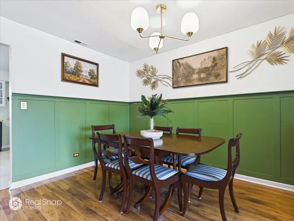 a view of a dining room with furniture and wooden floor