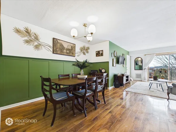 a view of a dining room with furniture and wooden floor