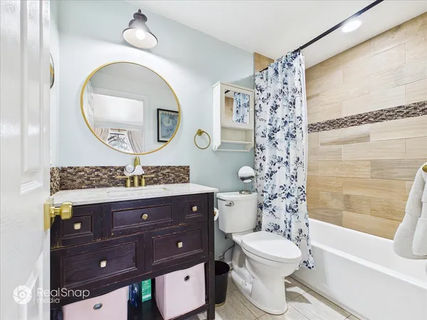 a bathroom with a toilet a sink and a mirror