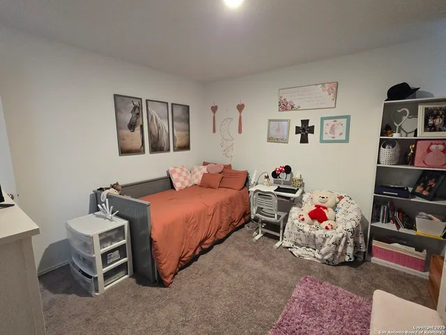 a bedroom with bed and a book shelf
