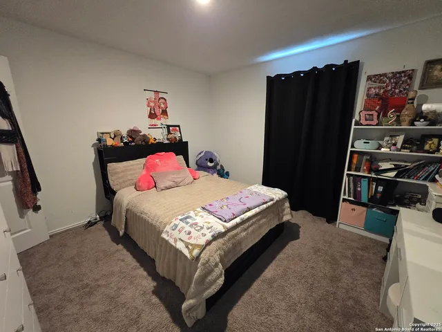 a bedroom with a bed and cabinets