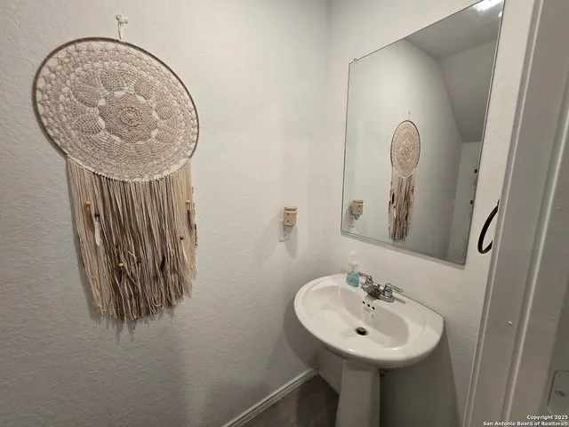 a bathroom with a sink a mirror and vanity