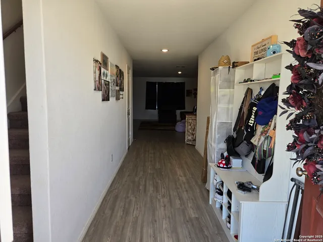 a view of a hallway with entryway and workspace
