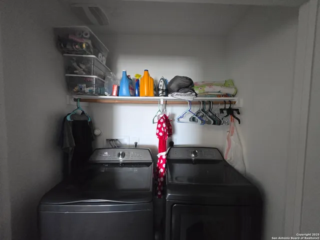 a room with rack on the wall and cabinets