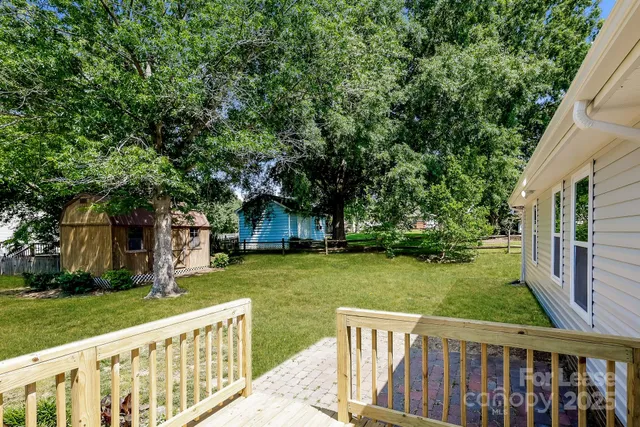 a view of a wooden deck and a garden