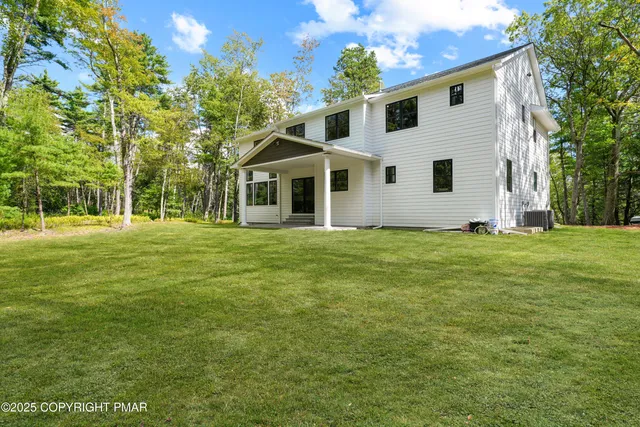 a front view of house with yard and trees