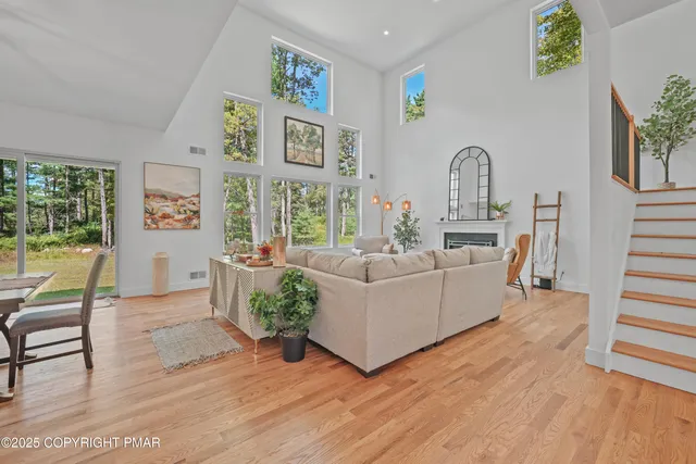 a living room with furniture and large windows