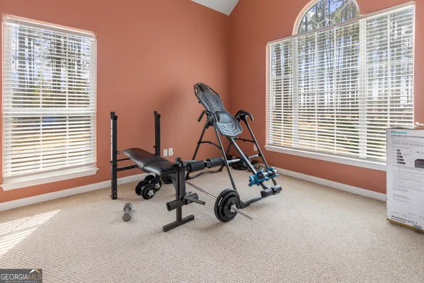a kitchen with stainless steel appliances a sink a stove a refrigerator cabinets and a window