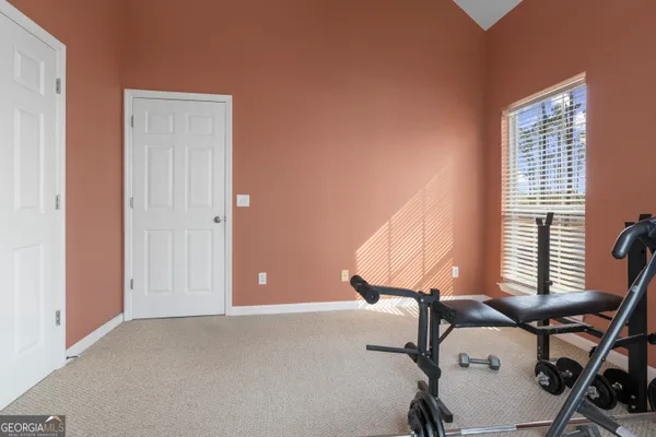 a bedroom with a bed dresser and a window
