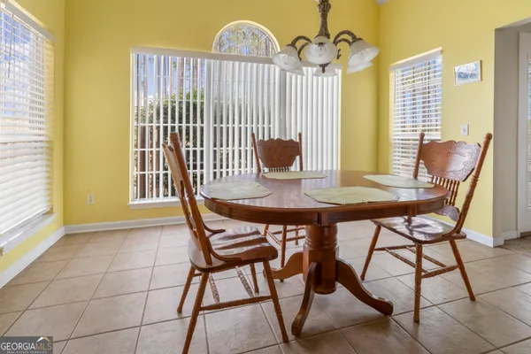 a spacious bathroom with a double vanity sink a large mirror and a shower