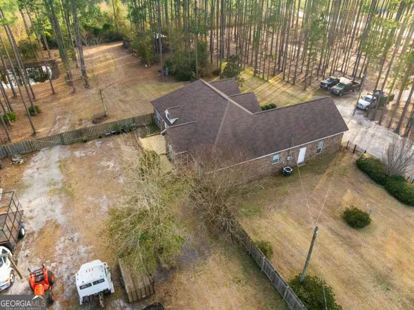 an aerial view of a house with a yard