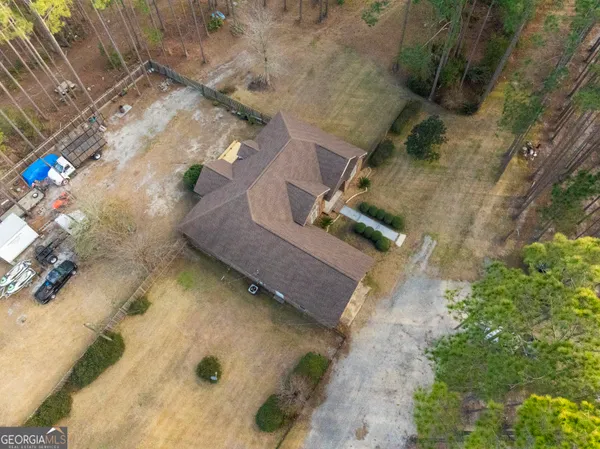 a view of a front of house with a small yard and plants