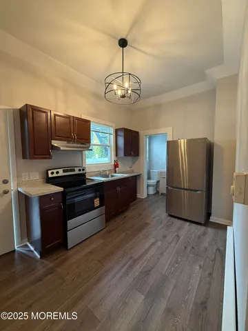 a kitchen with stainless steel appliances granite countertop a refrigerator stove and microwave