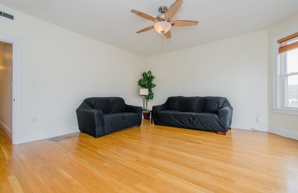 126 Minden Street, Unit 3 Boston, MA 02130 - Photo 4 of 12 a living room with furniture a chandelier and a window