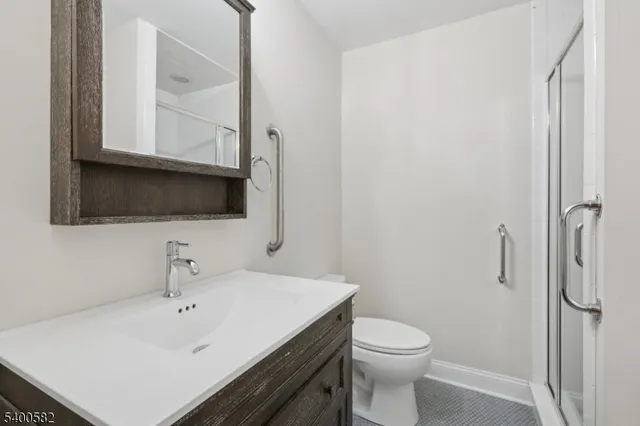 a bathroom with a sink a toilet and mirror