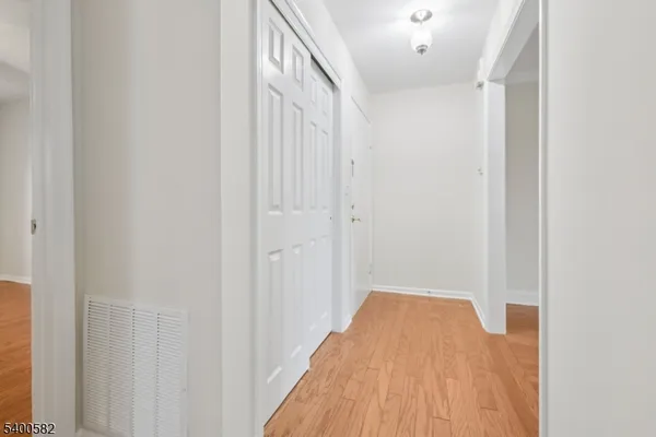 a view of a room with wooden floor