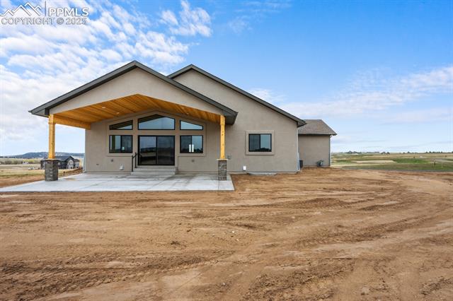 11762 Rambling Road Colorado Springs, CO 80908 - Photo 7 of 42 Stunning rear patio with wood accents and a view of Pikes Peak