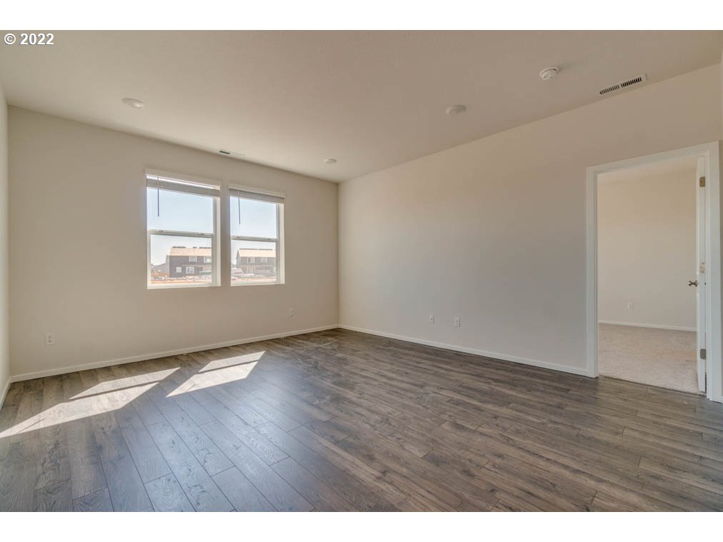 Undisclosed Address Eugene, OR 97404 - Photo 11 of 19 a view of an empty room with wooden floor and a window