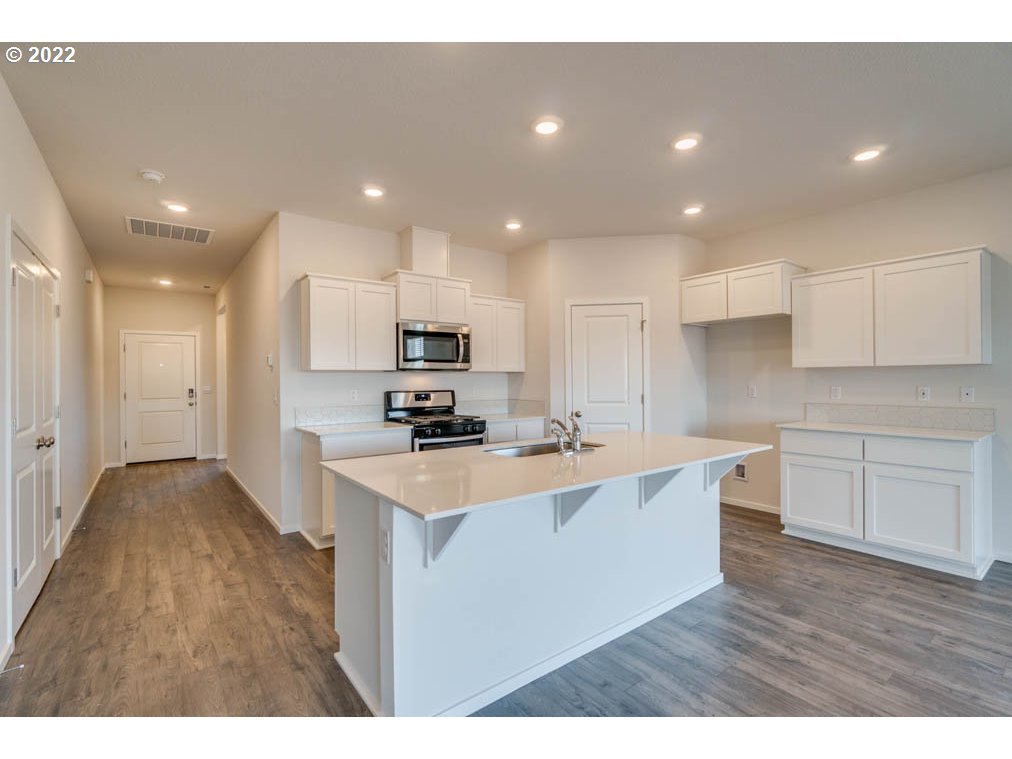Undisclosed Address Eugene, OR 97404 - Photo 9 of 19 a kitchen with stainless steel appliances a sink a stove a refrigerator cabinets and a refrigerator