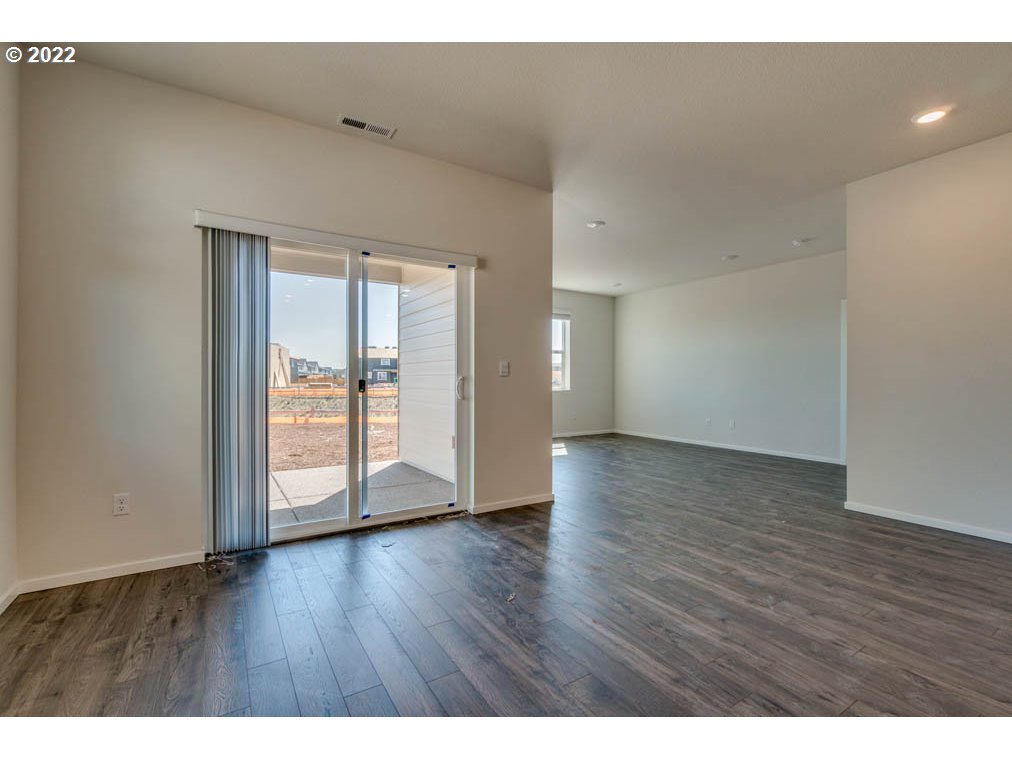 Undisclosed Address Eugene, OR 97404 - Photo 10 of 19 a view of an empty room with wooden floor and a window
