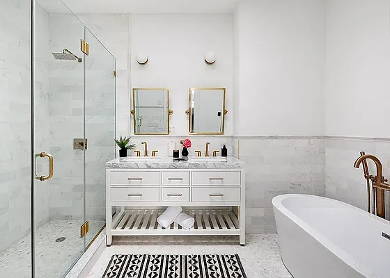 a bathroom with a bathtub a sink and a mirror