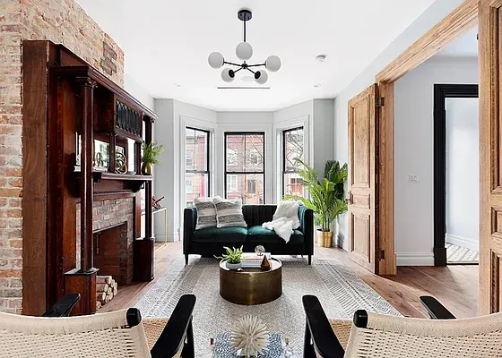 a living room with furniture potted plant and a window