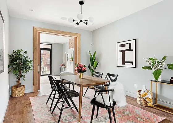 a view of a dining room with furniture and a potted plant