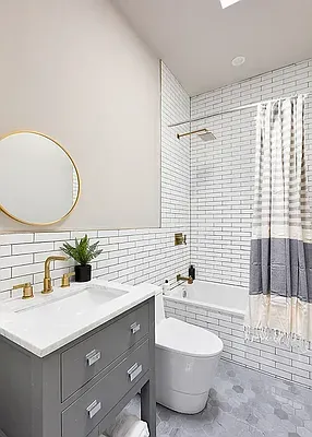 a bathroom with a double vanity sink mirror and bathtub