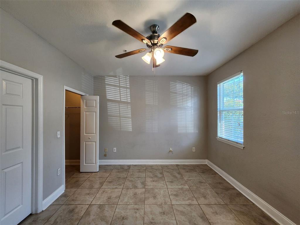3250 Corona Village Way, Unit 101 Orlando, FL 32835 - Photo 17 of 31 an empty room with closet and windows