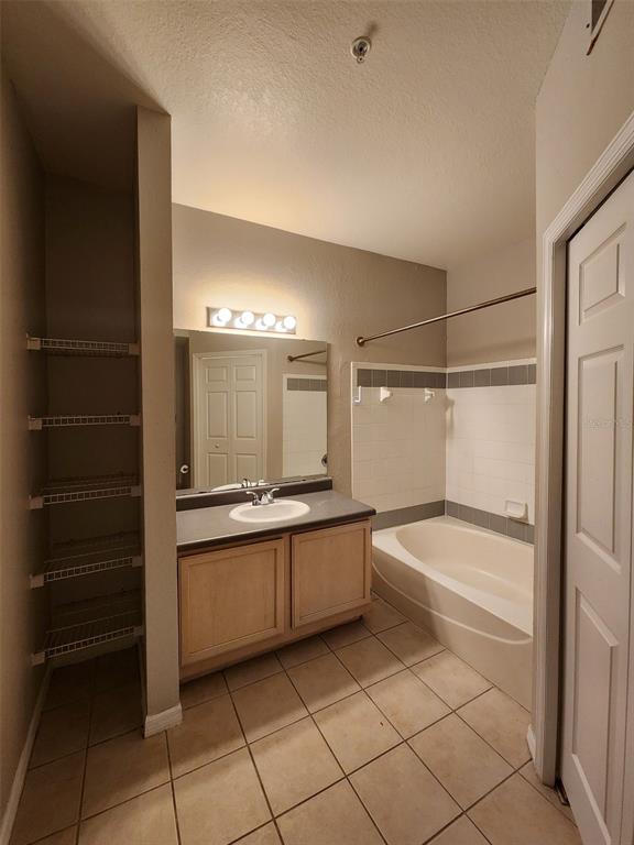 3250 Corona Village Way, Unit 101 Orlando, FL 32835 - Photo 20 of 31 a bathroom with a tub a sink and mirrors