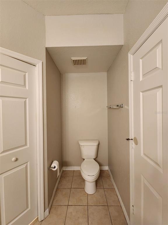 3250 Corona Village Way, Unit 101 Orlando, FL 32835 - Photo 21 of 31 a bathroom with a toilet