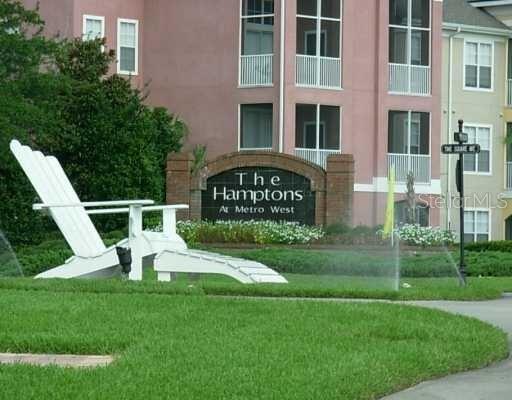 3250 Corona Village Way, Unit 101 Orlando, FL 32835 - Photo 25 of 31 a view of a front of a building with a yard