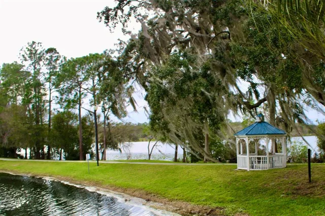 a view of a patio with a table and chairs under an umbrella