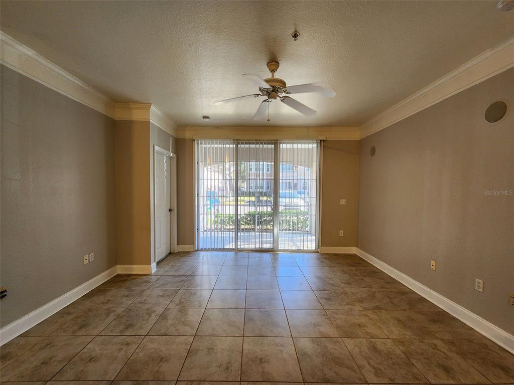 3250 Corona Village Way, Unit 101 Orlando, FL 32835 - Photo 4 of 31 a view of an empty room with glass door