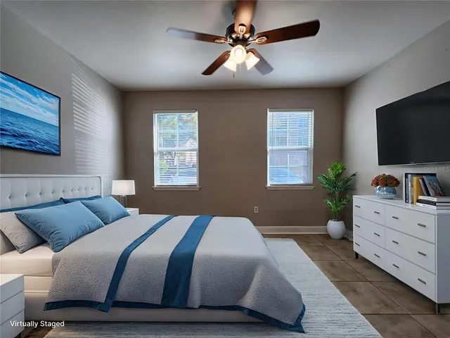 a bedroom with a large bed and a flat screen tv