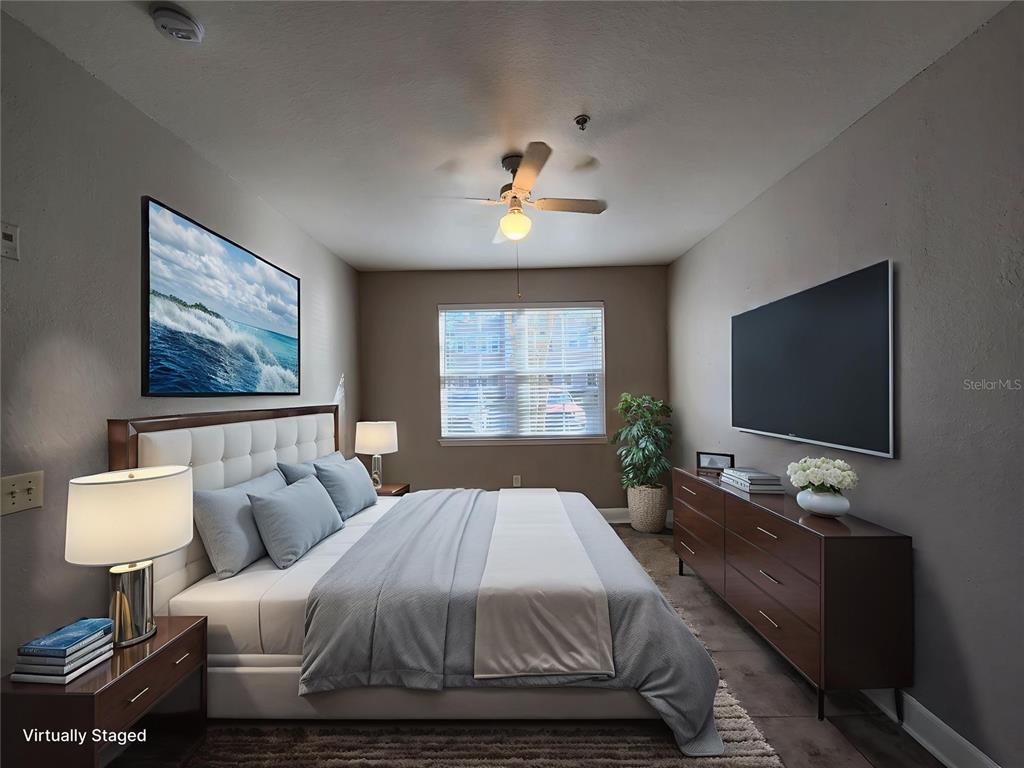 3250 Corona Village Way, Unit 101 Orlando, FL 32835 - Photo 7 of 31 a bedroom with a bed and a flat screen tv