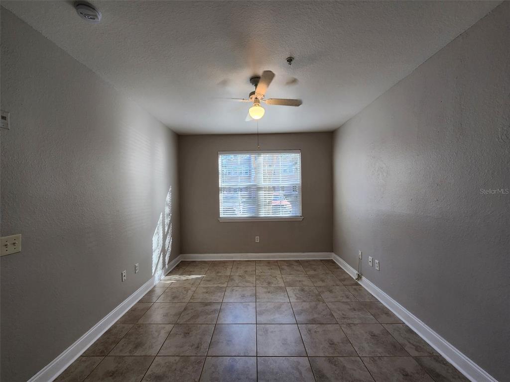 3250 Corona Village Way, Unit 101 Orlando, FL 32835 - Photo 8 of 31 wooden floor in an empty room with a window