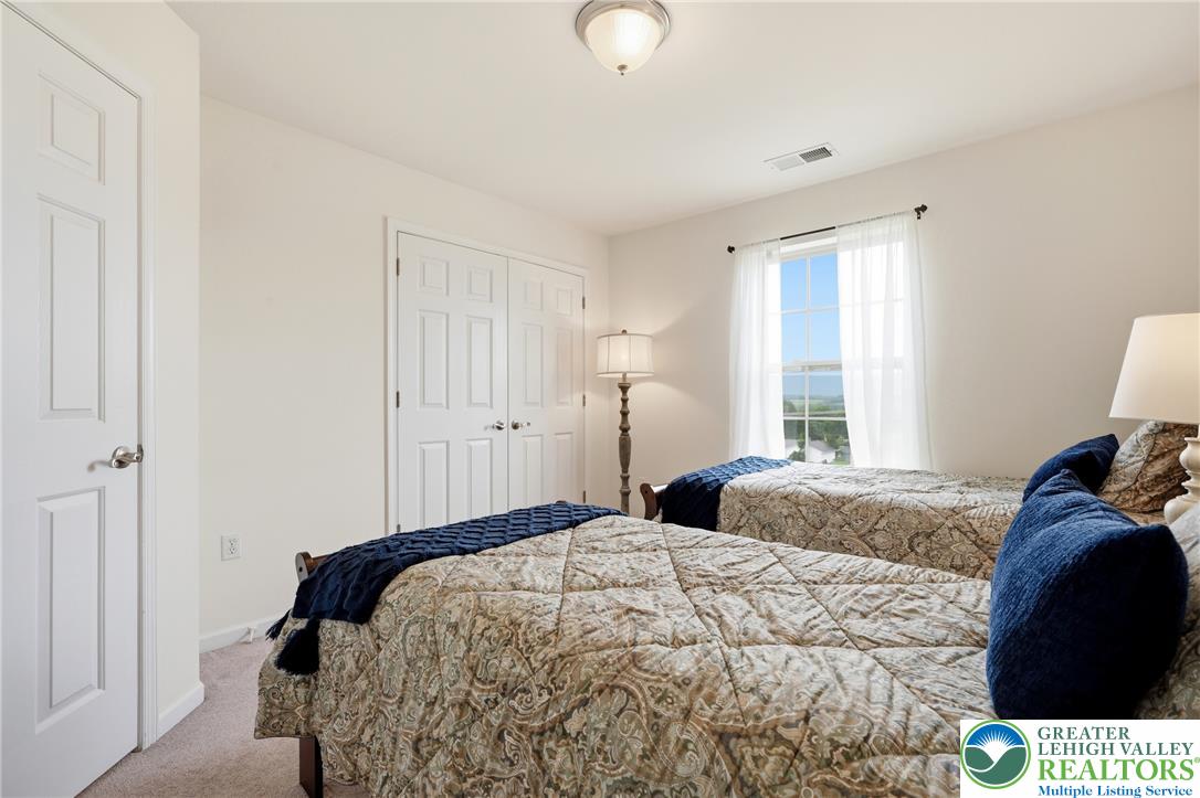 245 East Dell Road Bath, PA 18014 - Photo 48 of 99 A comfortable bedroom, naturally illuminated by a large window, offers a serene retreat.