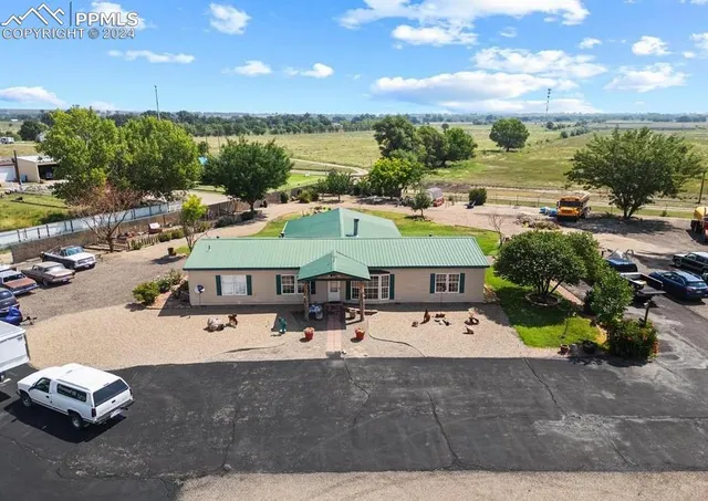 a view of a swimming pool with a patio and a garden