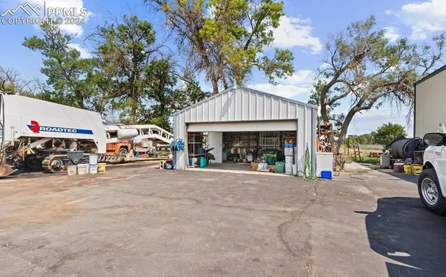 a view of a house with backyard and a tree